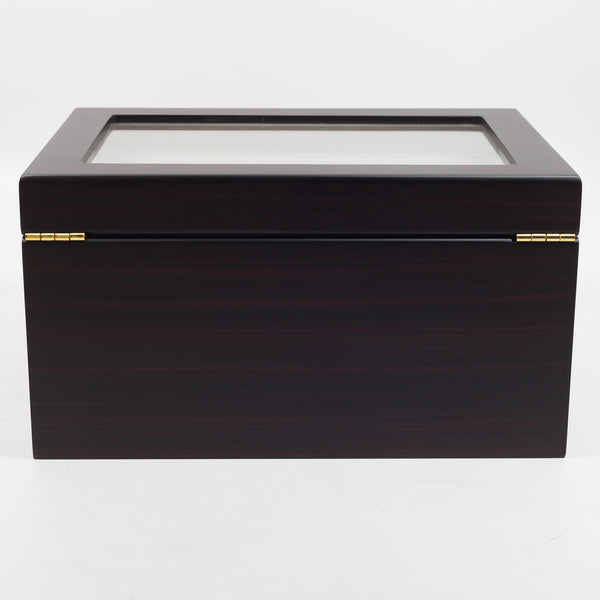 a black piece of luggage sitting on top of a box 