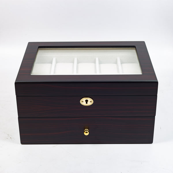 a black piece of luggage sitting on top of a box 